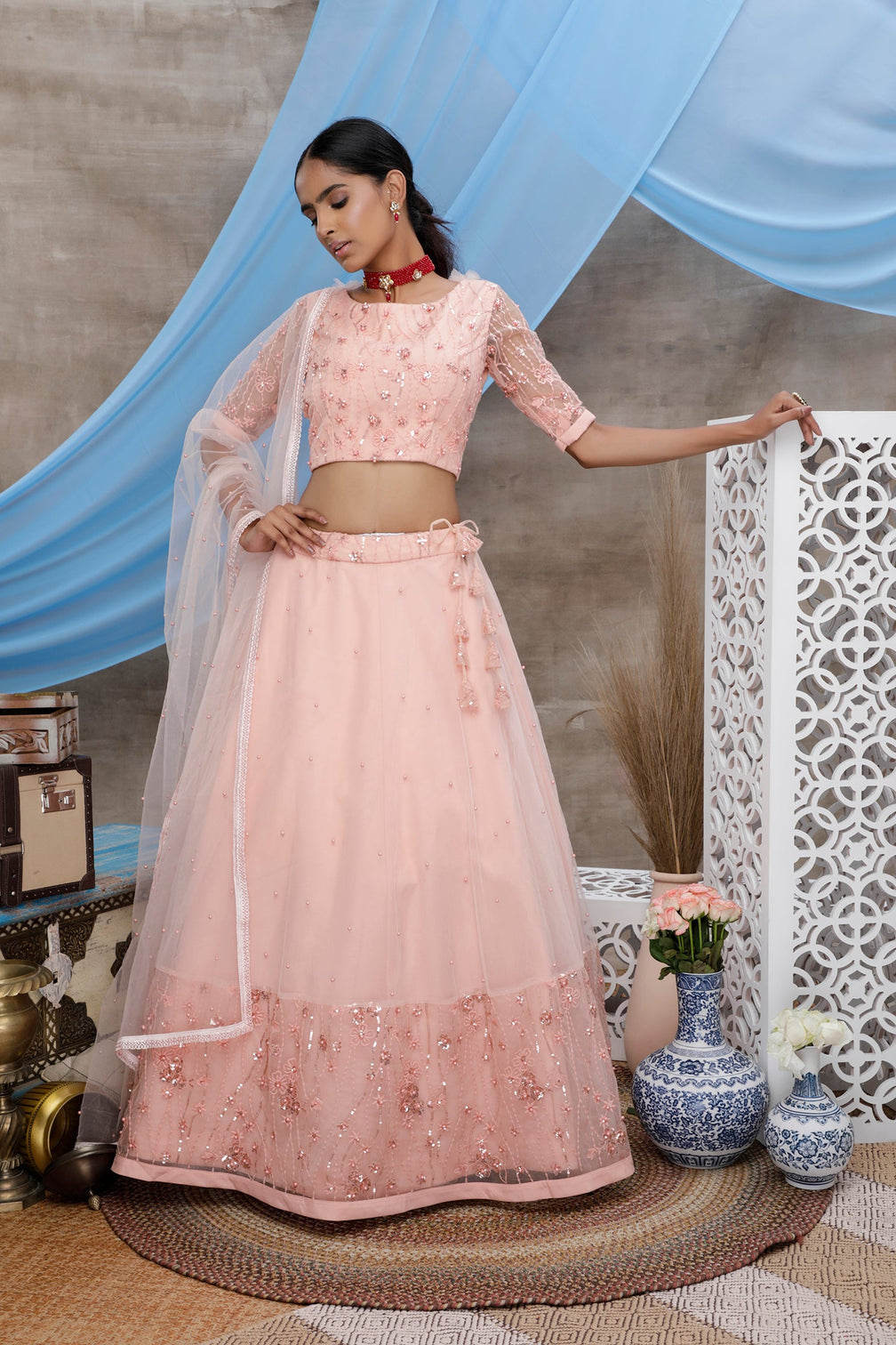 Peach Thread And Sequence Embroidered With All Over Pearl Rivet Stud Pasting Net Semi Stitched Bridal Lehenga