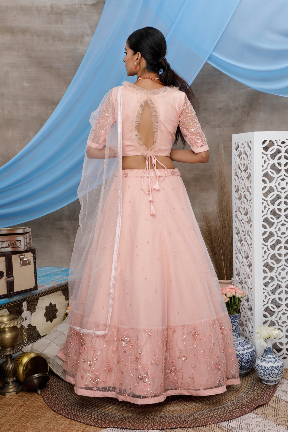 Peach Thread And Sequence Embroidered With All Over Pearl Rivet Stud Pasting Net Semi Stitched Bridal Lehenga