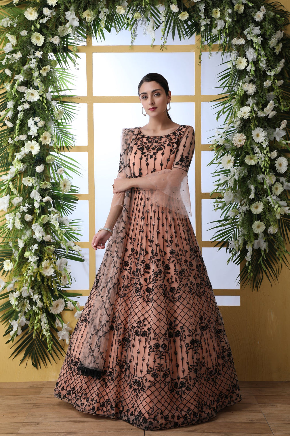 Sensational Peach Colored Soft Net Base Festive Wear Designer Gown