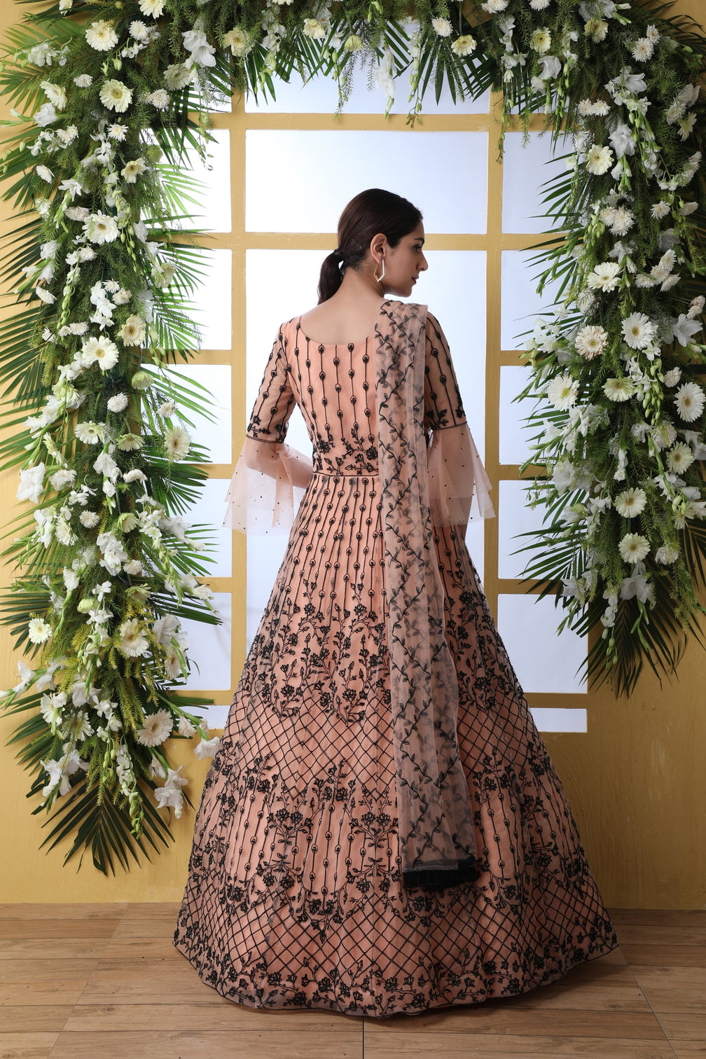 Sensational Peach Colored Soft Net Base Festive Wear Designer Gown