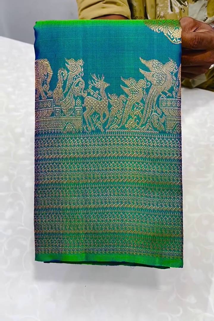 Embellished Rama Soft Banarasi Silk Saree With Gossamer Blouse Piece