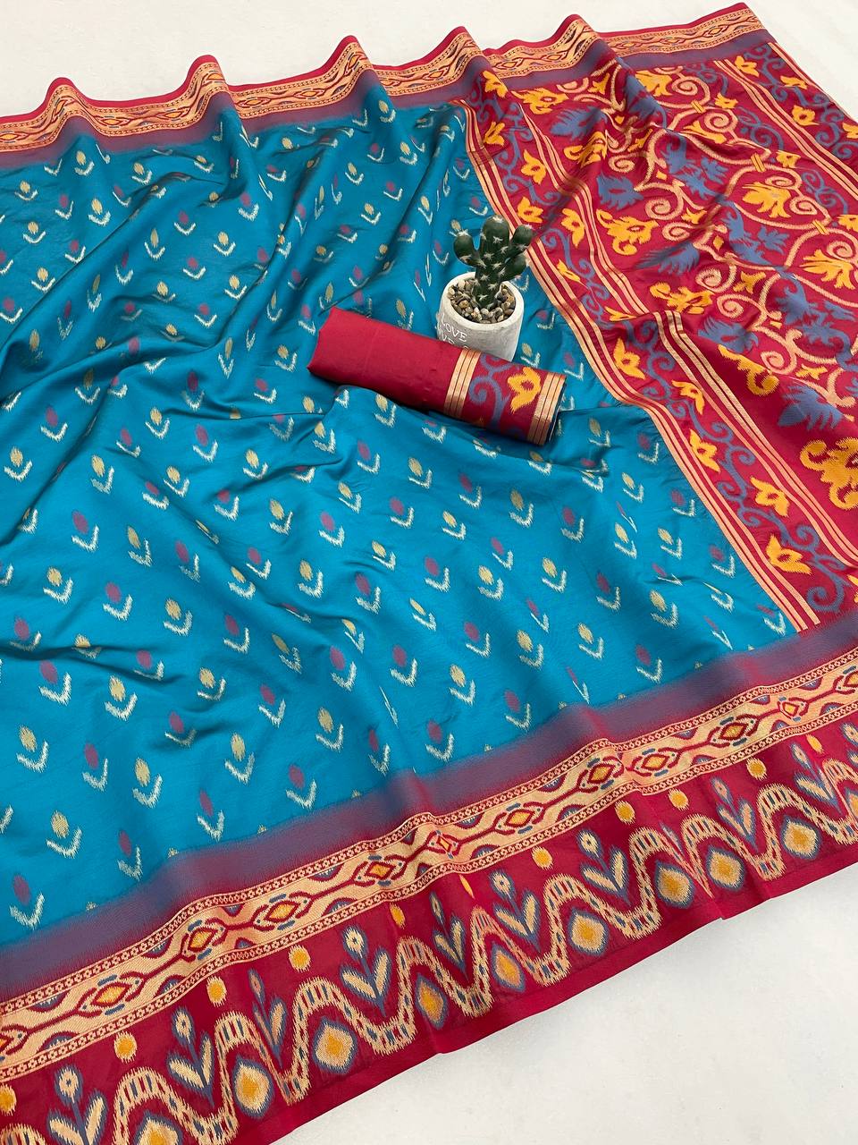 Symmetrical Firozi Banarasi Ikkat Silk Saree With Cynosure Blouse Piece
