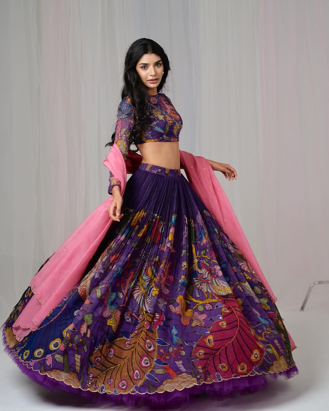Traditional purple kalamkari lehenga set with peacock motif and pink dupatta