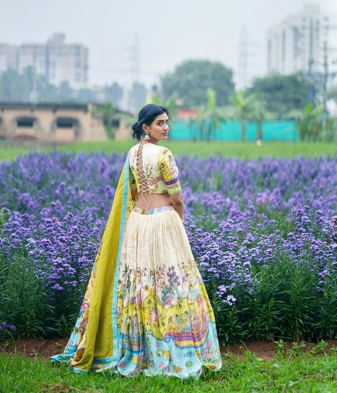 Cream and mustard kalamkari lehenga with pastoral motif and blue border