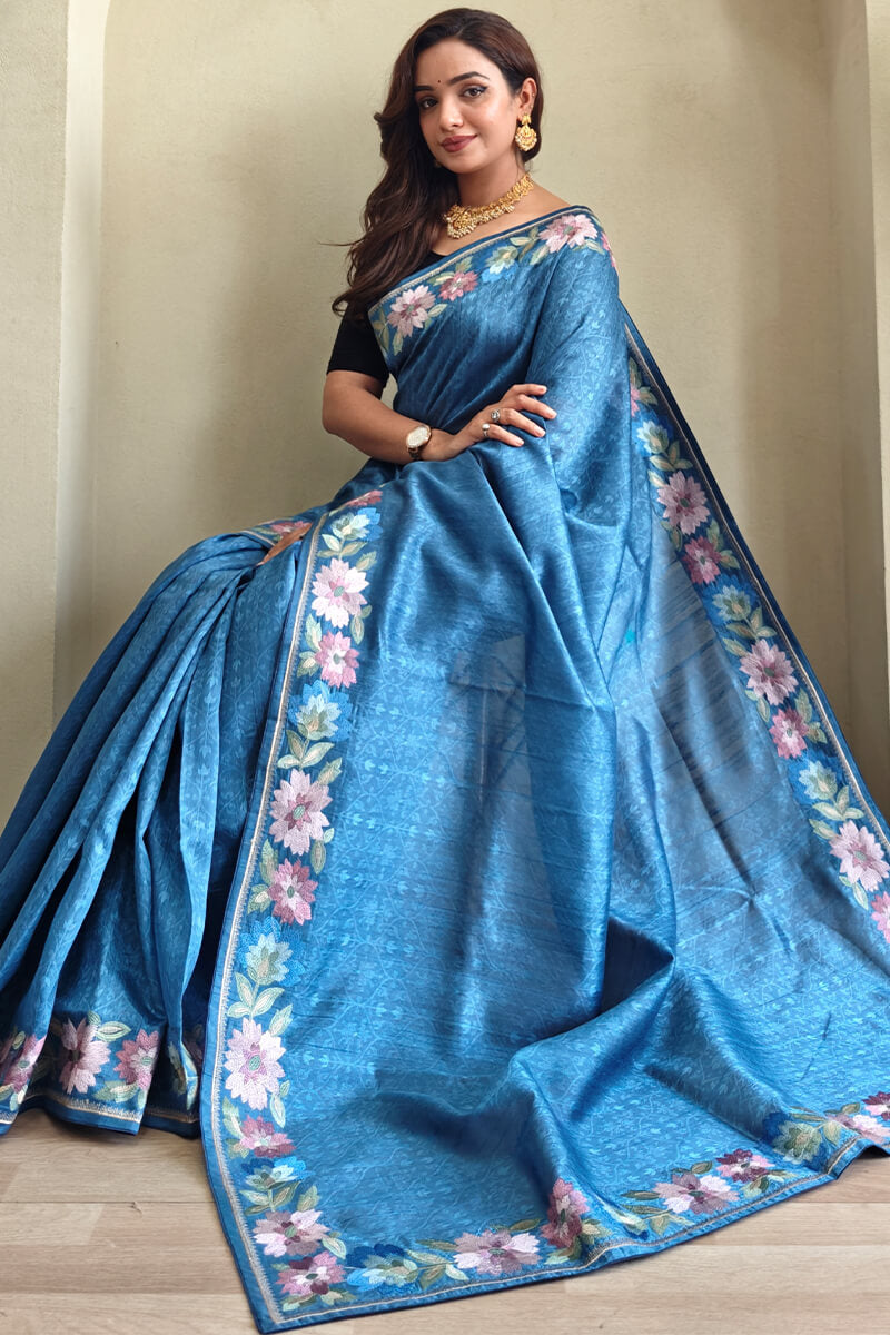 Cynosure Blue Embroidery Work Tussar Silk Saree With Classy Blouse Piece