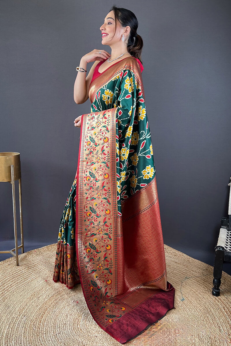 Adorning Dark Green Patola Silk Saree with Deserving Blouse Piece