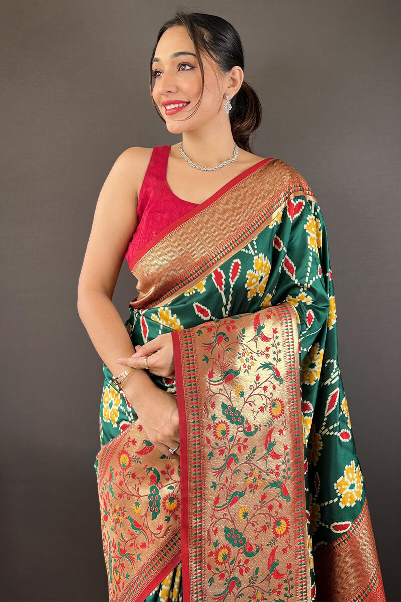 Adorning Dark Green Patola Silk Saree with Deserving Blouse Piece