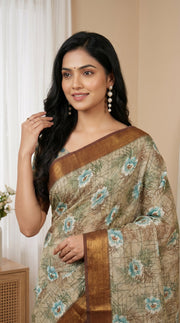 Beige aqua blue floral tissue saree with zari border and tassel pallu