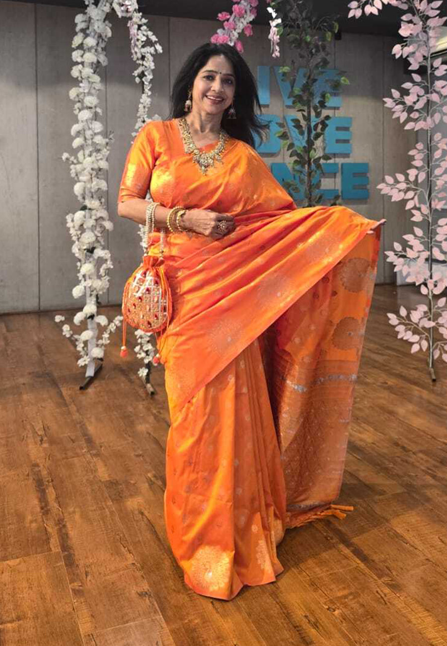 Orange soft silk dual zari woven saree with peacock border