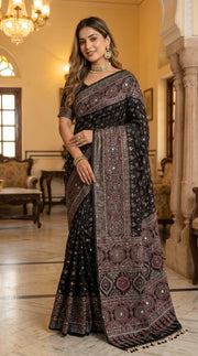 Black modal silk ajrakh printed saree with heritage medallion motifs rich traditional pallu tassel detailing mameraa