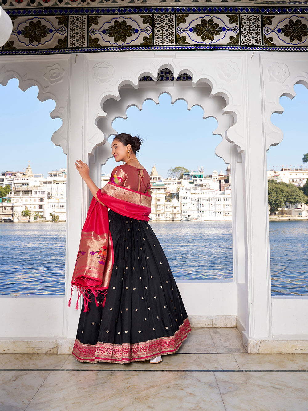 Elegant black jacquard silk lehenga choli with zari weaving matching potli purse