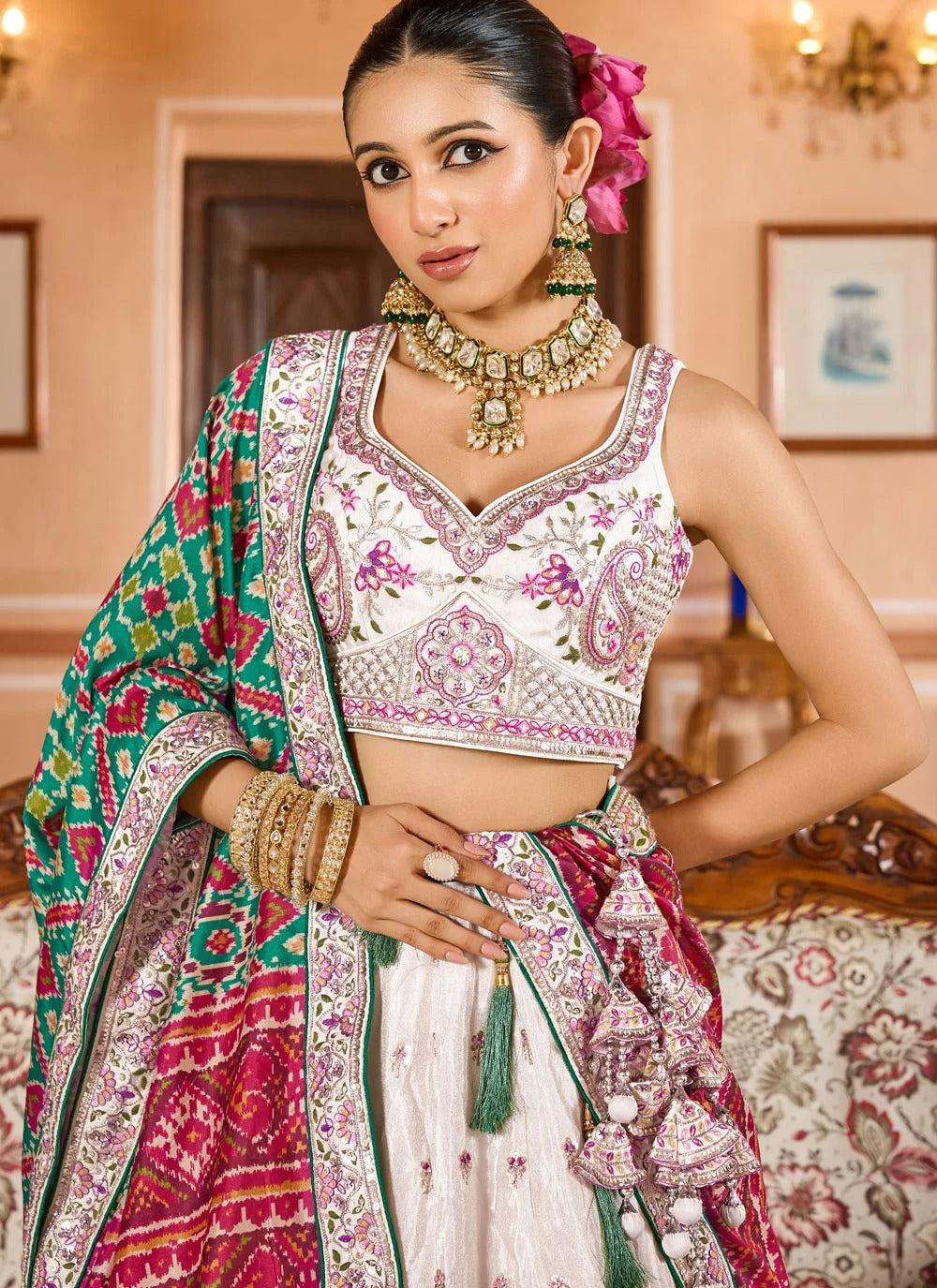 Exquisite cream engagement lehenga in tissue with patola dupatta zari embroidery