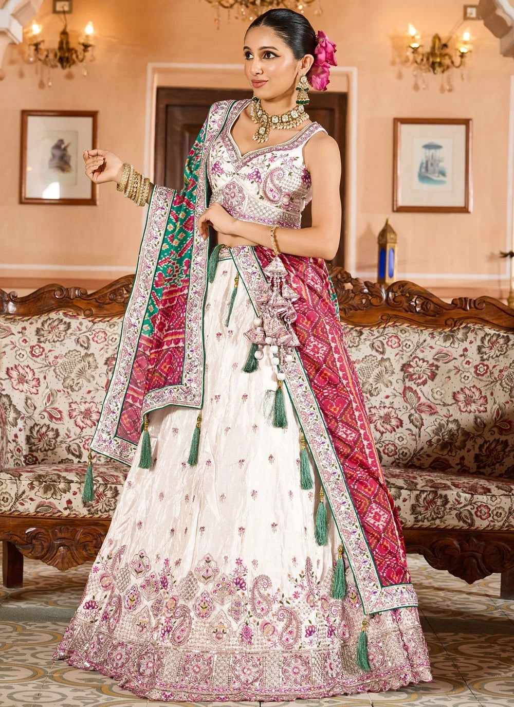 Exquisite cream engagement lehenga in tissue with patola dupatta zari embroidery