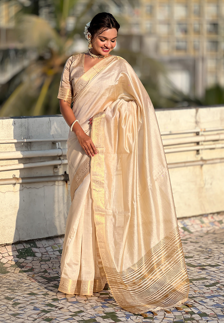 Graceful cream tussar silk saree with zari woven border