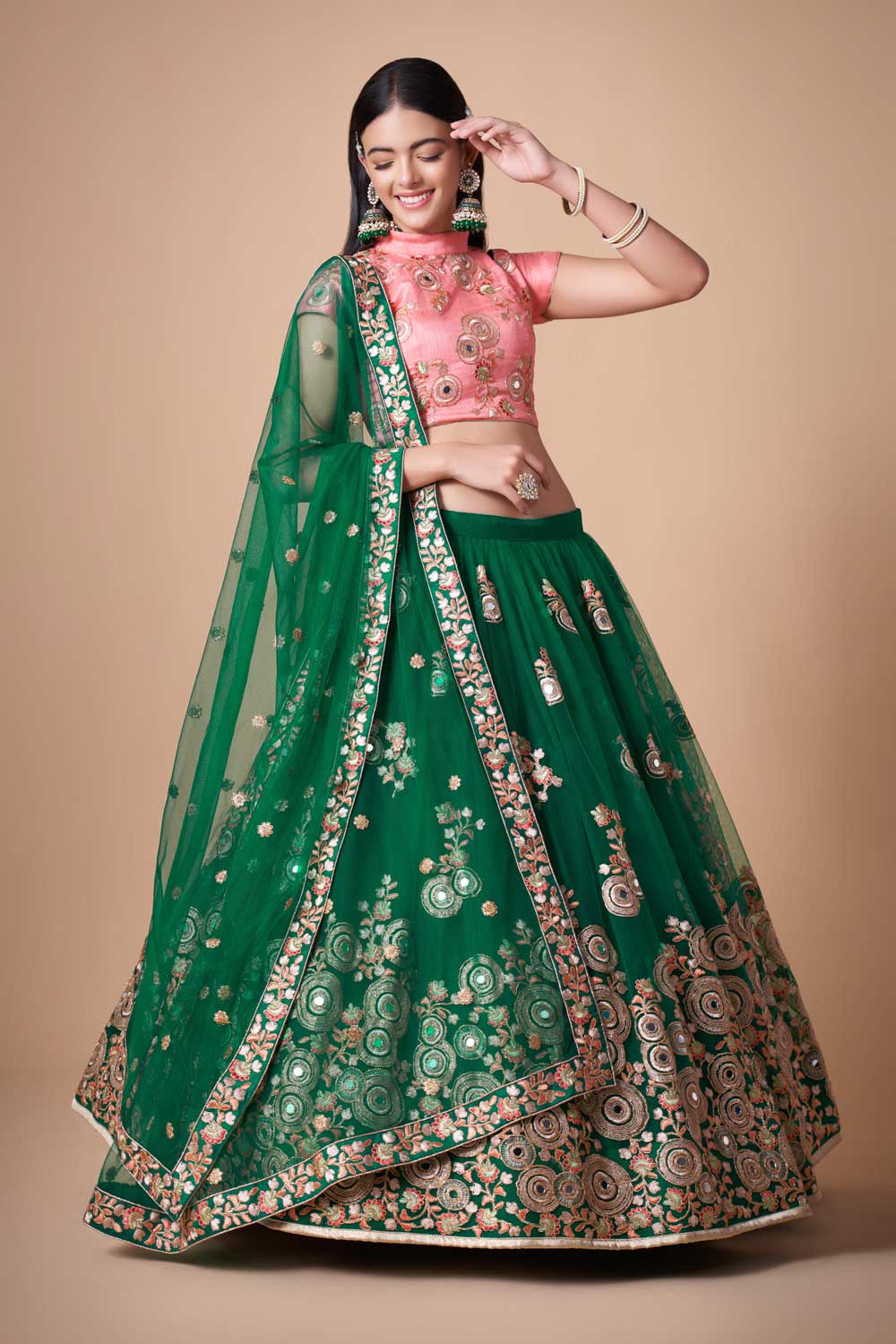 Dazzling green mirror work net lehenga with intricate dori embroidery