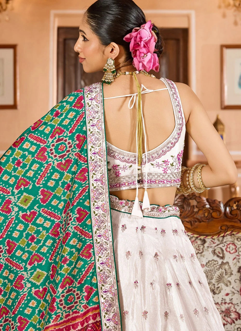 Exquisite cream engagement lehenga in tissue with patola dupatta zari embroidery