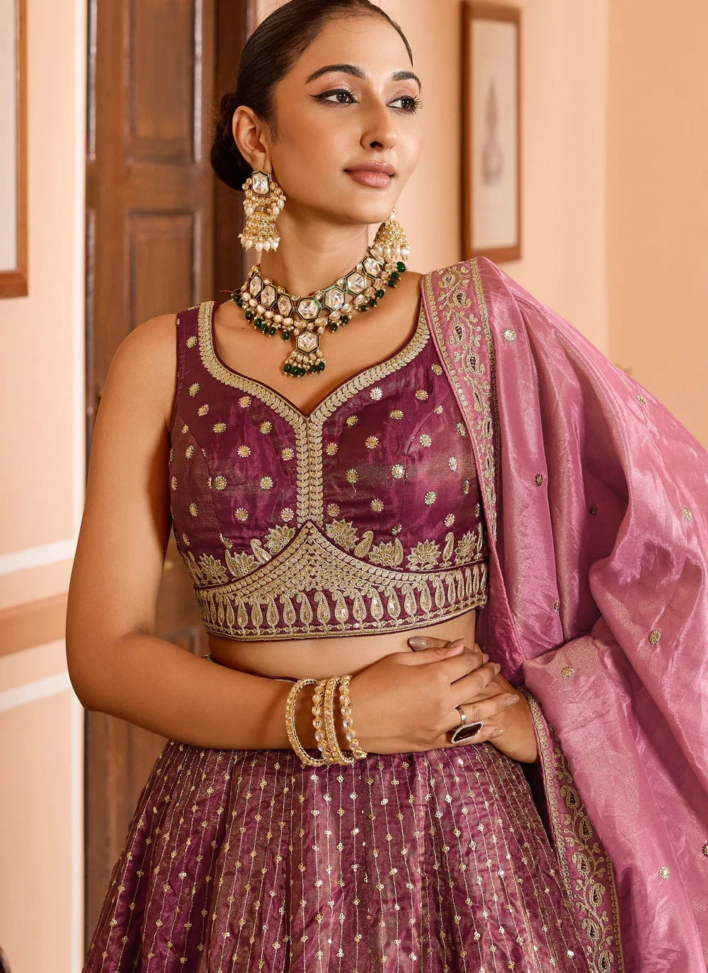 Luxury rose gold engagement lehenga in tissue silk with zari embroidery