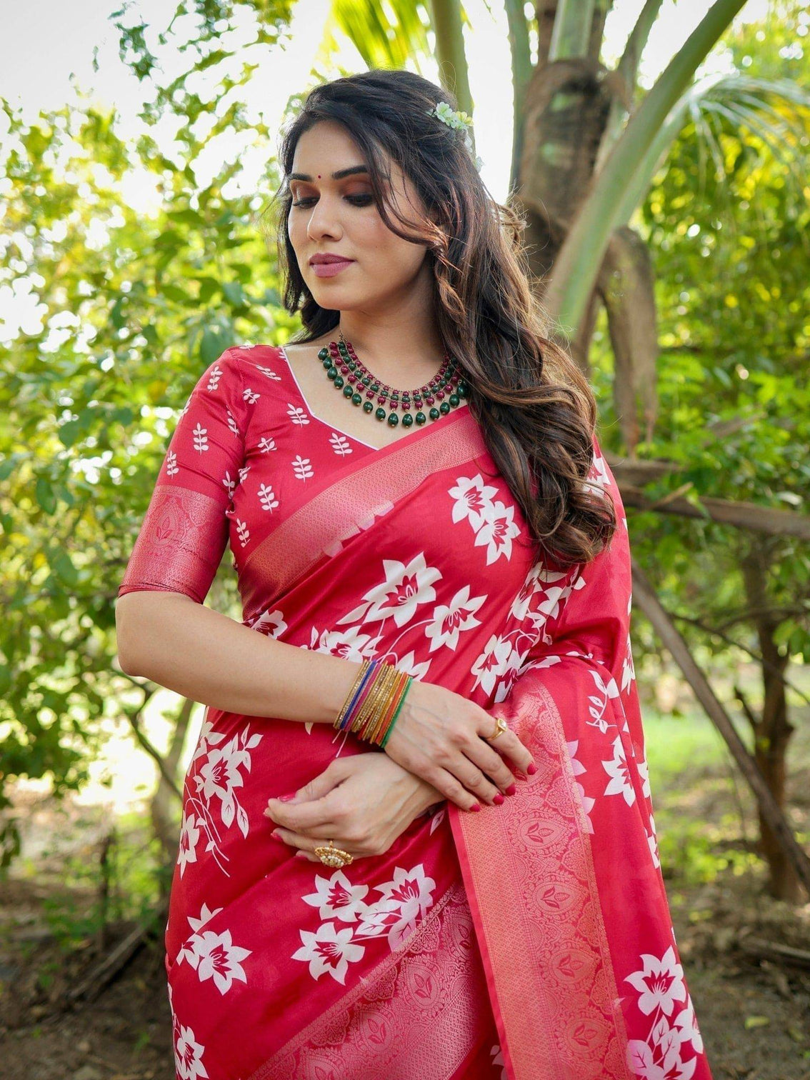 Graceful red tussar silk saree with white floral print zari border tassel pallu