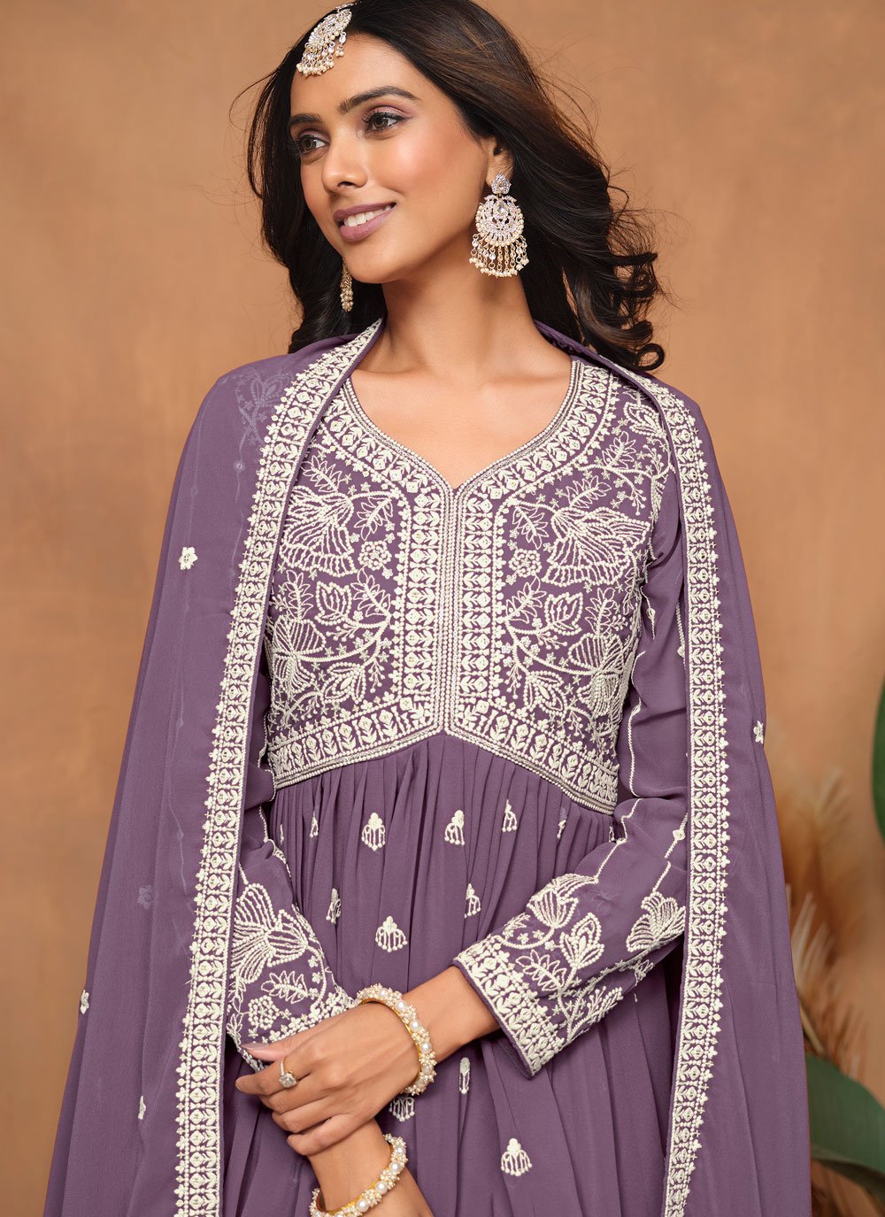 Elegant purple embroidered sharara style suit in faux georgette