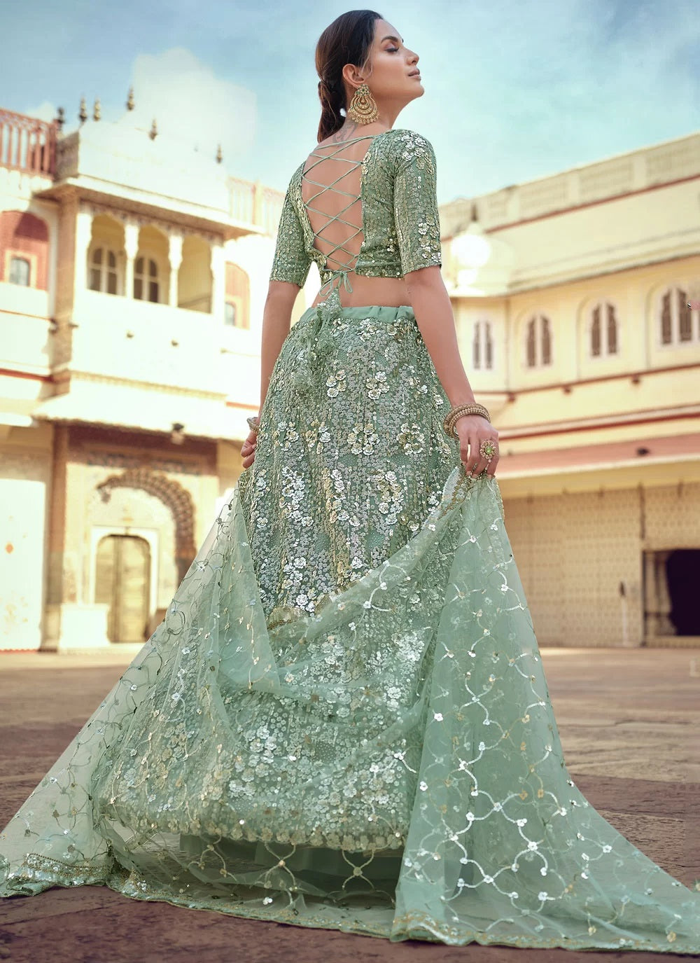 Elegant soft net green engagement lehenga with sequins thread and stone work