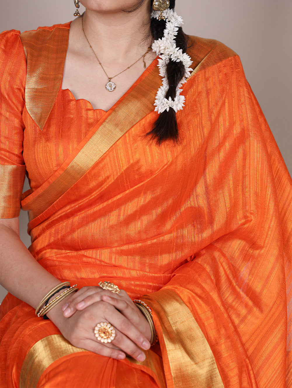 Orange raw silk saree with intricate zari weaving unstitched blouse
