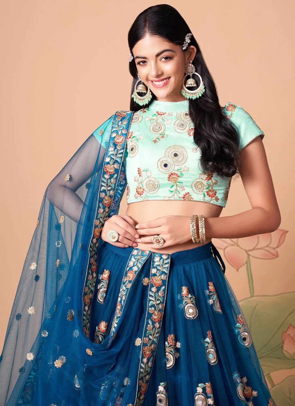 Exquisite net lehenga with floral thread embroidery and mirror work