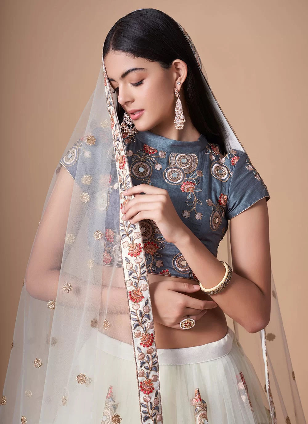 Fashionable net lehenga with dori and mirror work embroidery in off white