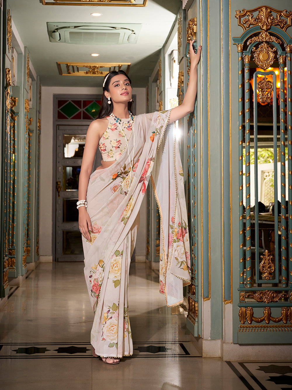 Off white georgette printed saree with pearl lace border