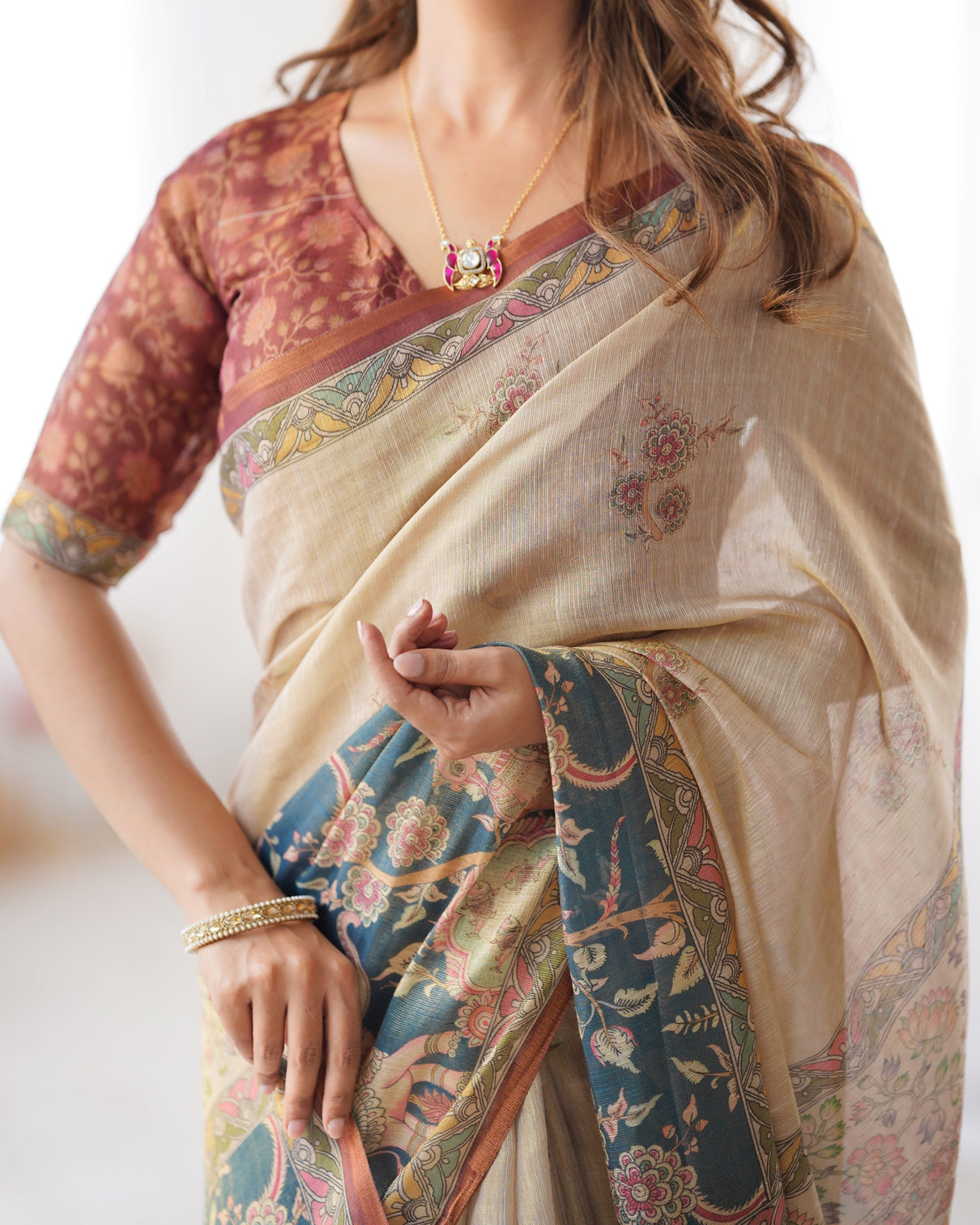 Beige handloom cotton saree with maroon blouse and multicolor royal procession pallu