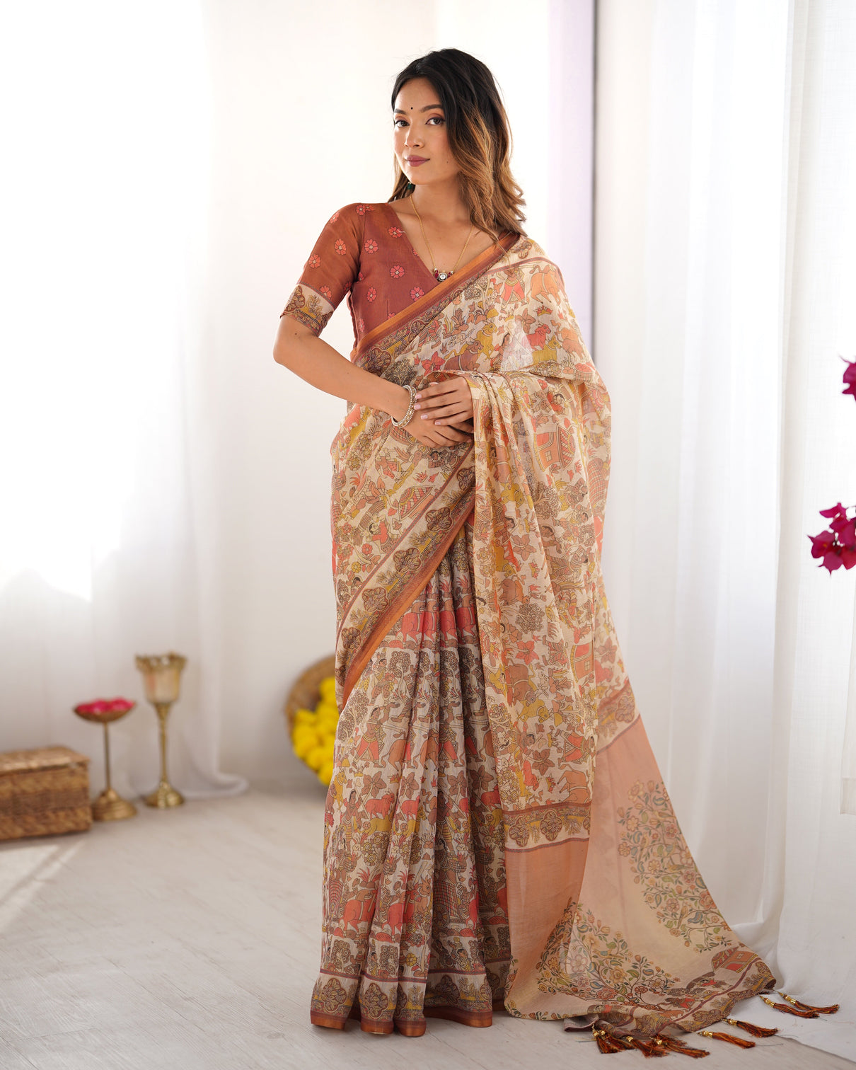 Beige handloom cotton saree with rust blouse and village celebration print