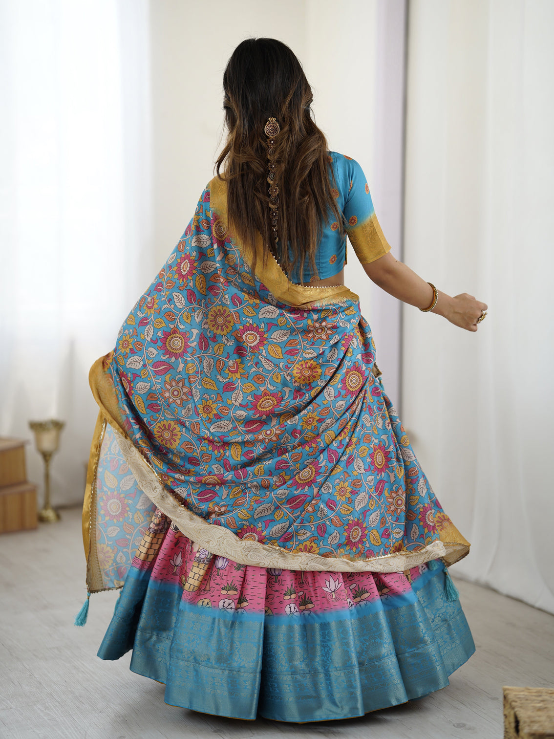 Elegant kalamkari lehenga in blue and peach with floral dupatta and flared skirt