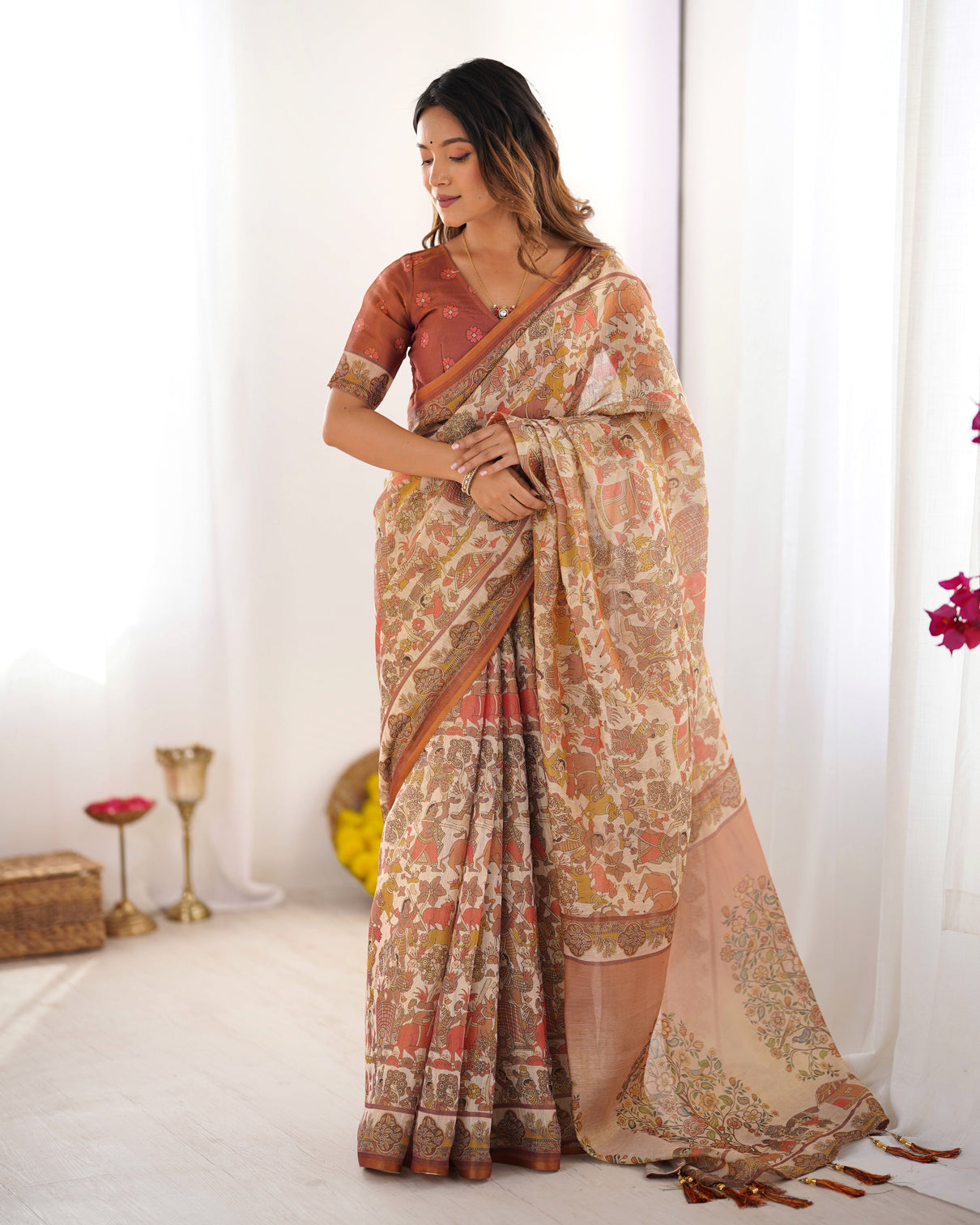 Beige handloom cotton saree with rust blouse and village celebration print