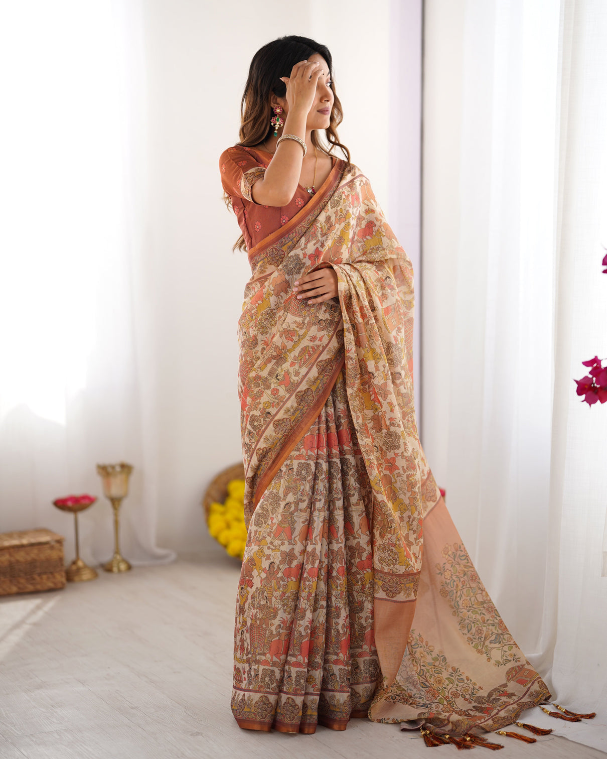 Beige handloom cotton saree with rust blouse and village celebration print
