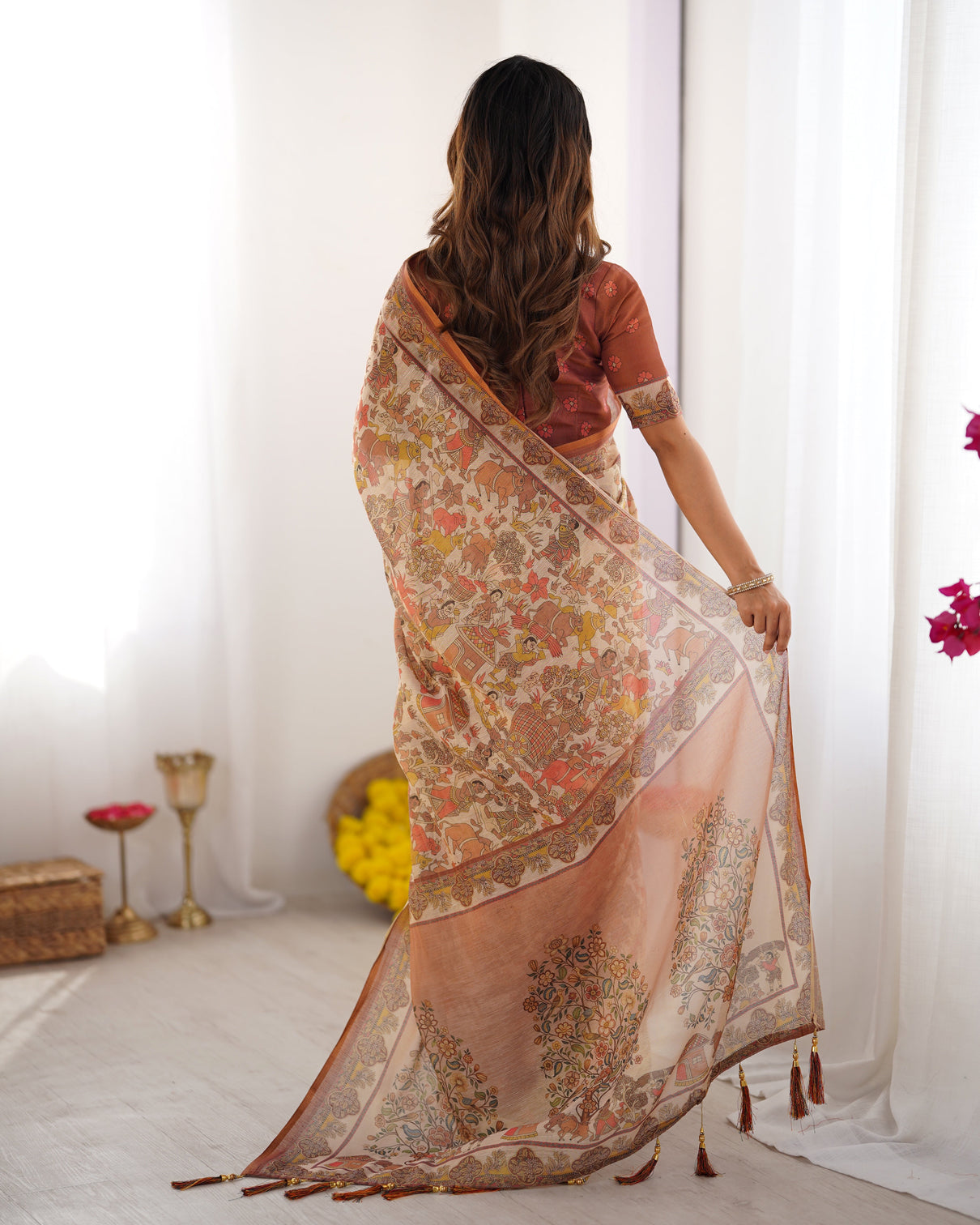 Beige handloom cotton saree with rust blouse and village celebration print