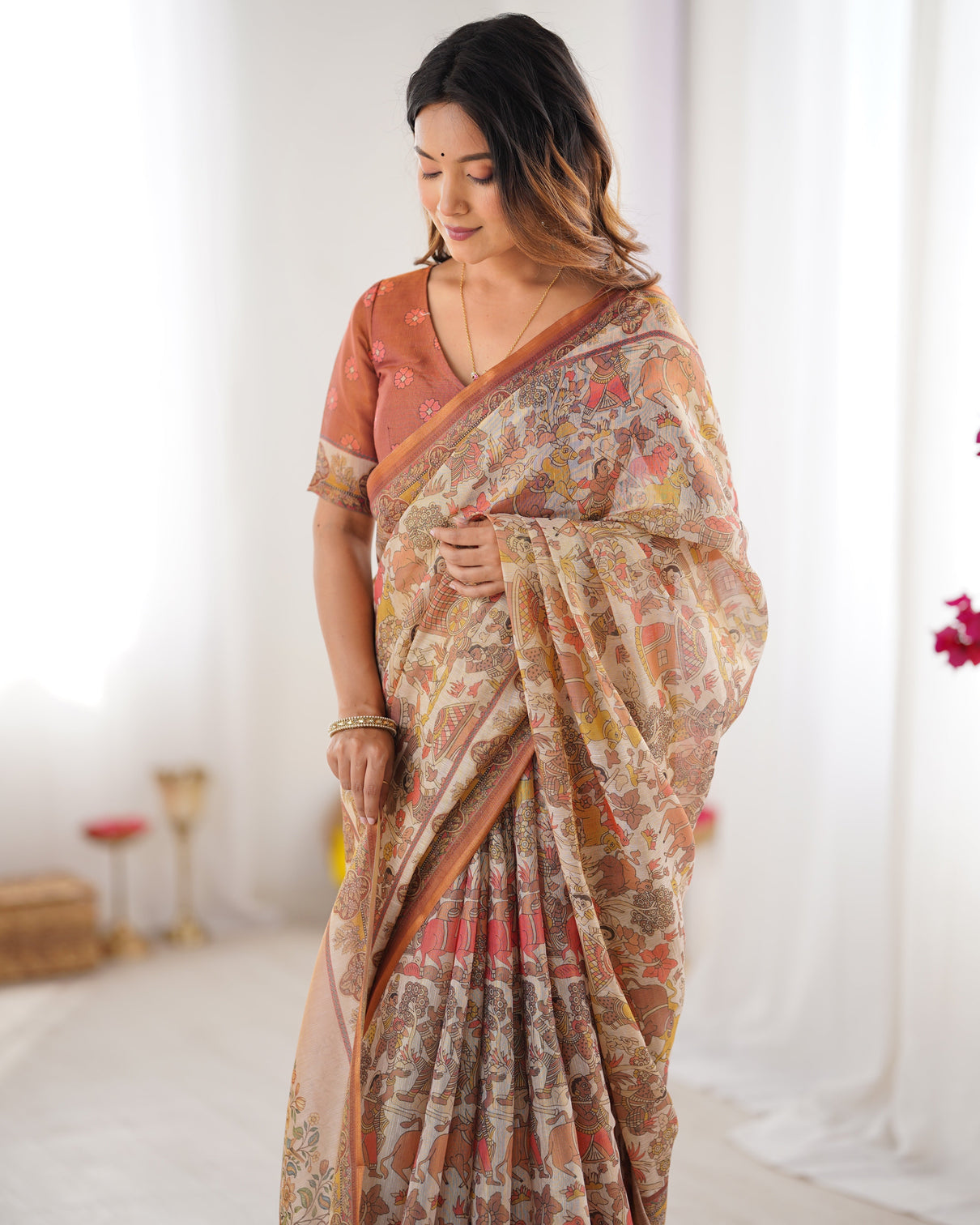 Beige handloom cotton saree with rust blouse and village celebration print