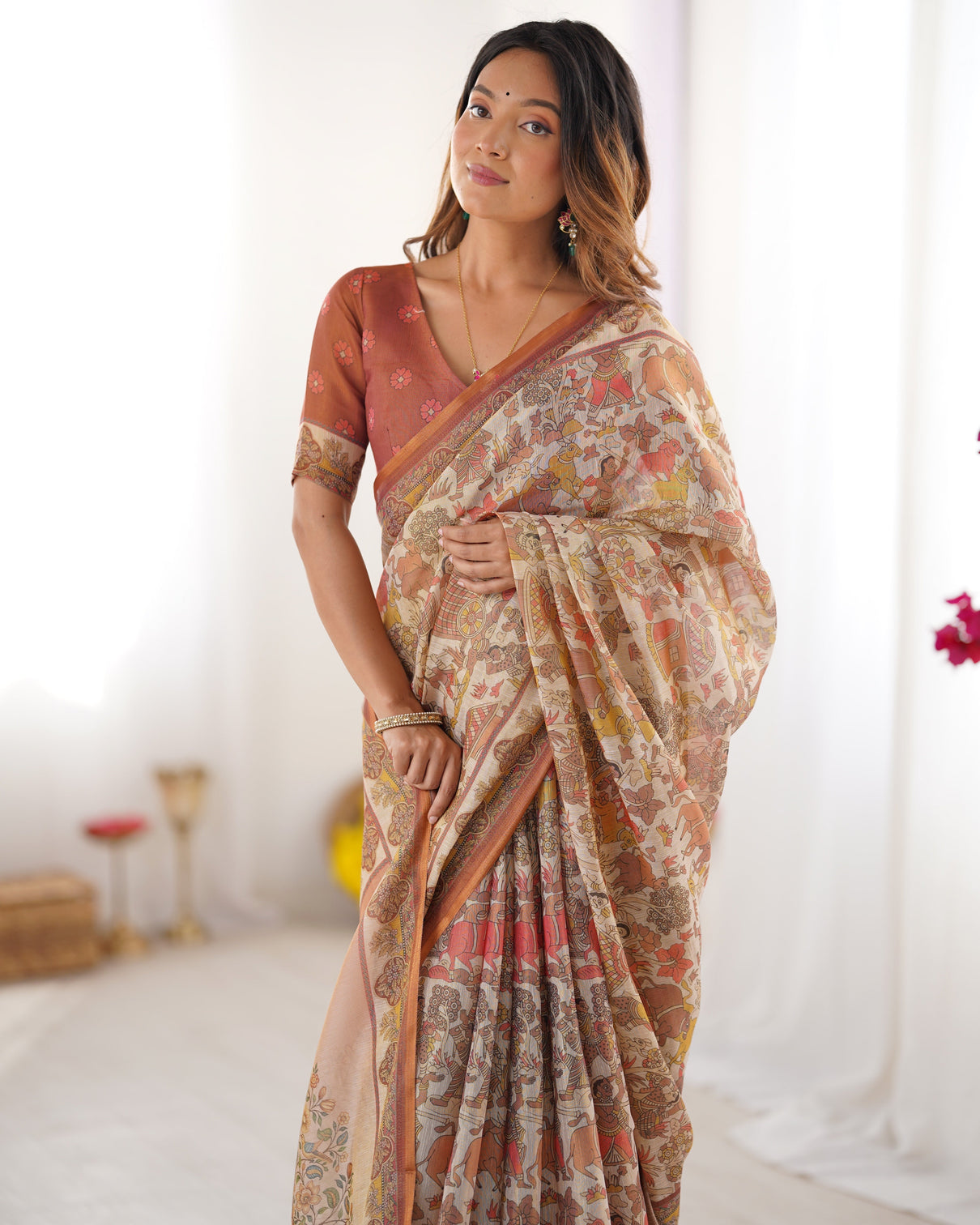 Beige handloom cotton saree with rust blouse and village celebration print
