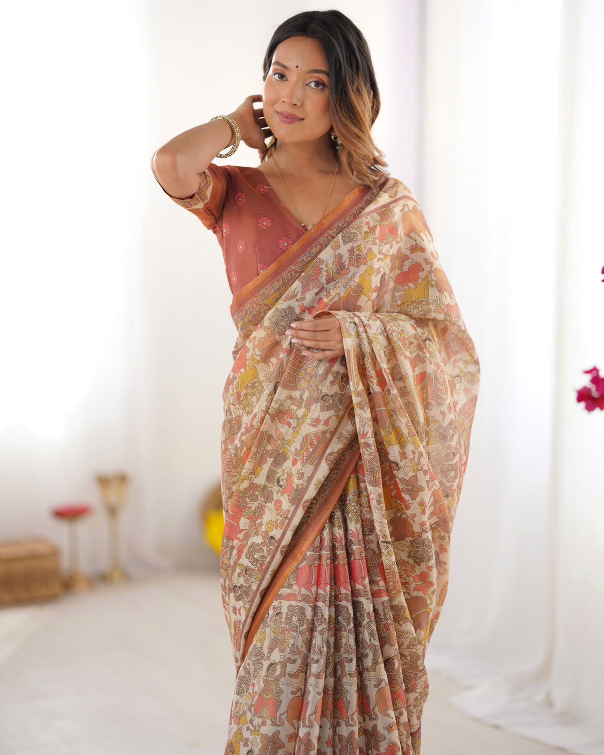 Beige handloom cotton saree with rust blouse and village celebration print