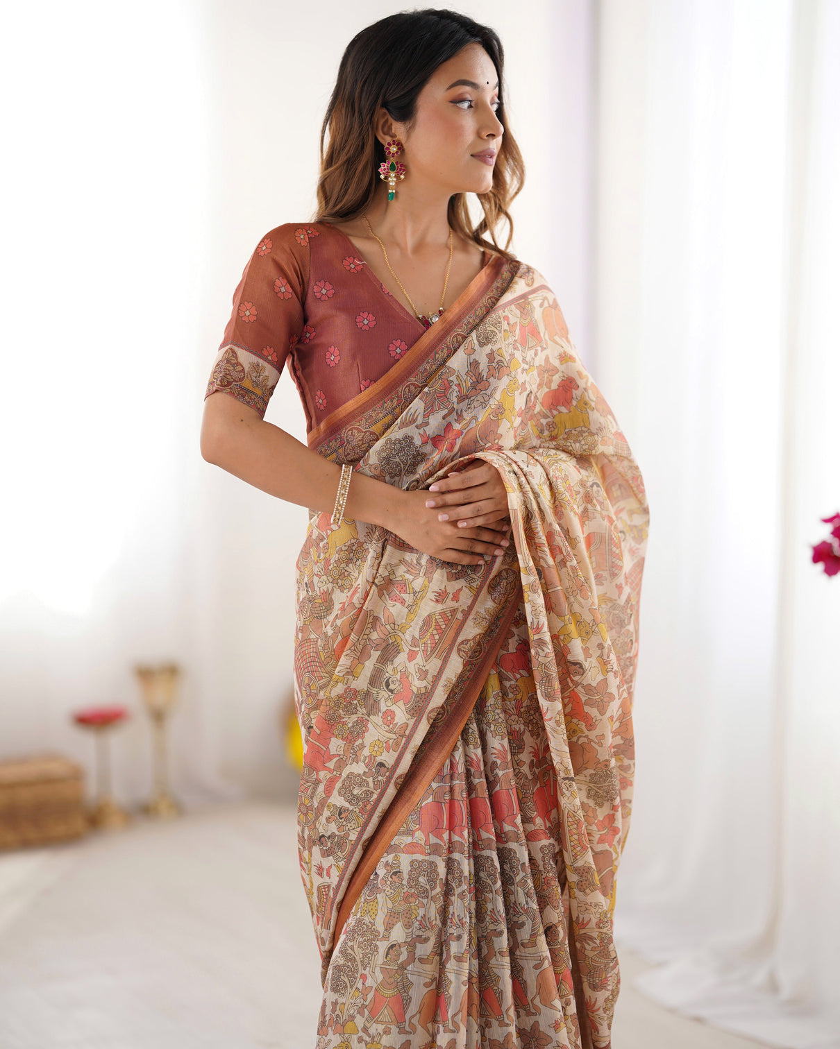 Beige handloom cotton saree with rust blouse and village celebration print