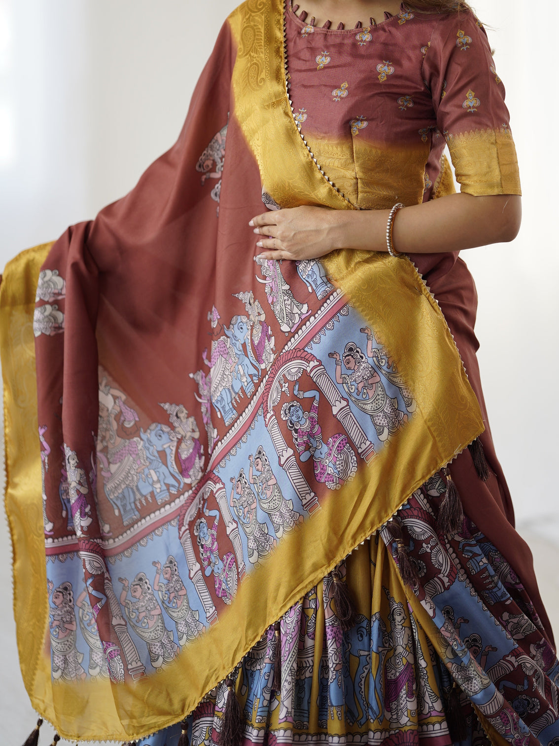 Elegant kalamkari lehenga in maroon and mustard with flared skirt and dupatta