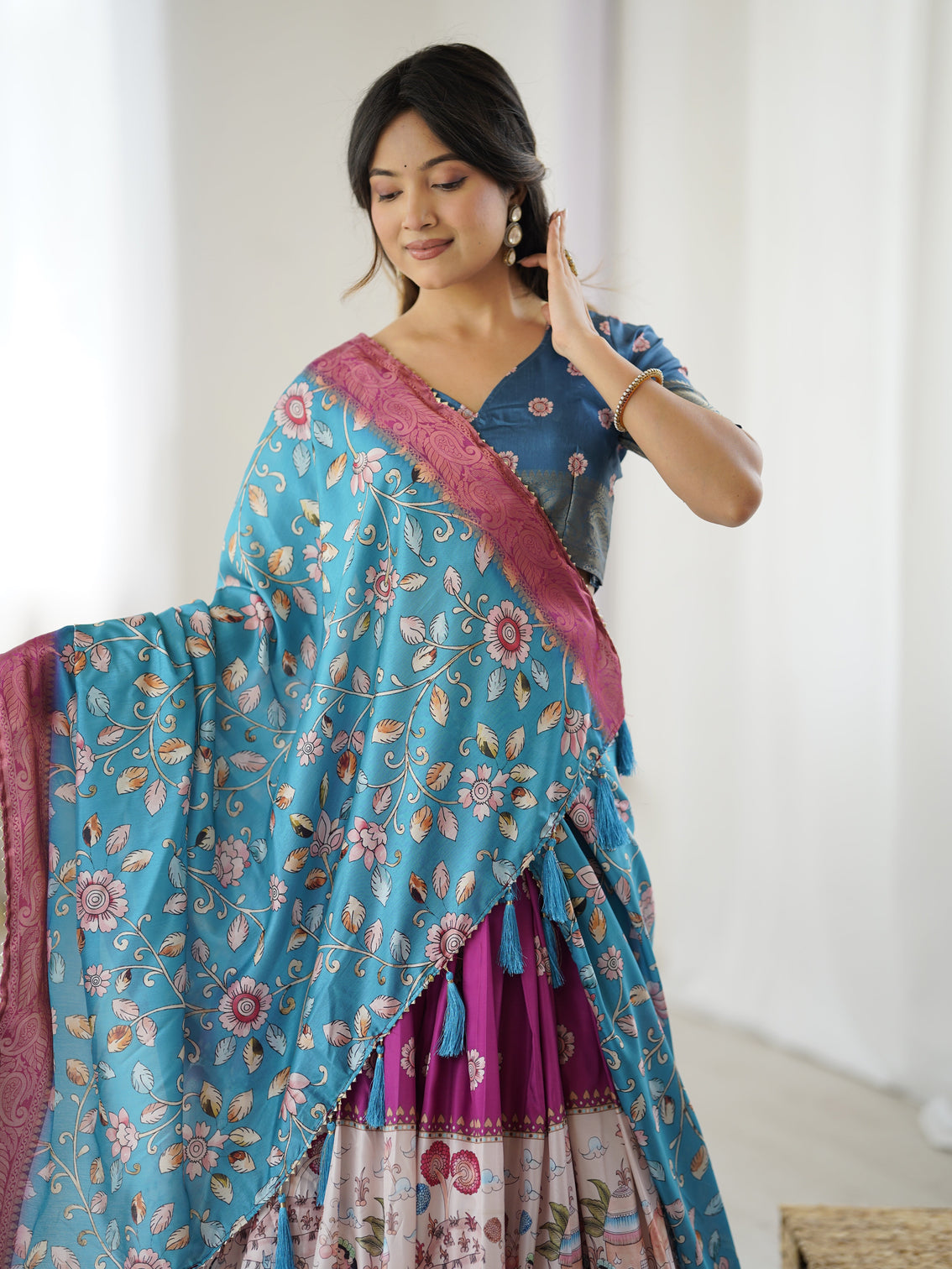 Peacock blue kalamkari lehenga with divine print and floral embroidered dupatta