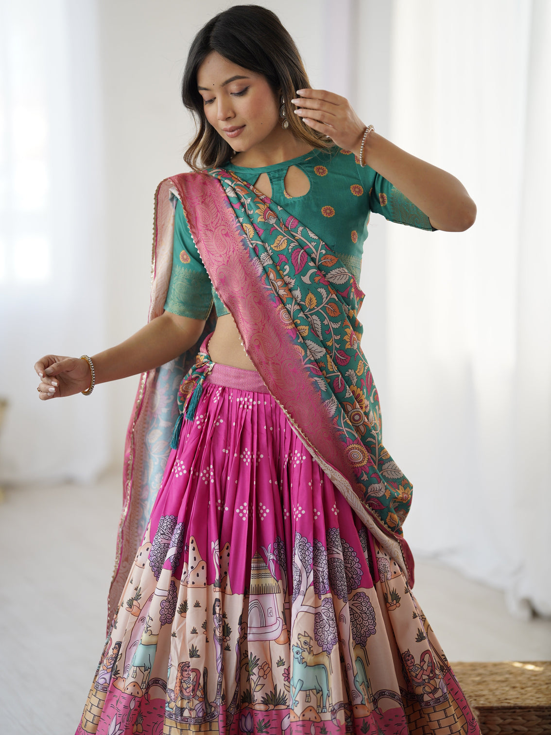 Elegant kalamkari lehenga in fuchsia pink and green with floral dupatta and story print skirt