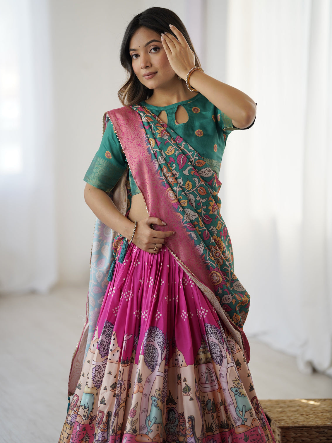 Elegant kalamkari lehenga in fuchsia pink and green with floral dupatta and story print skirt