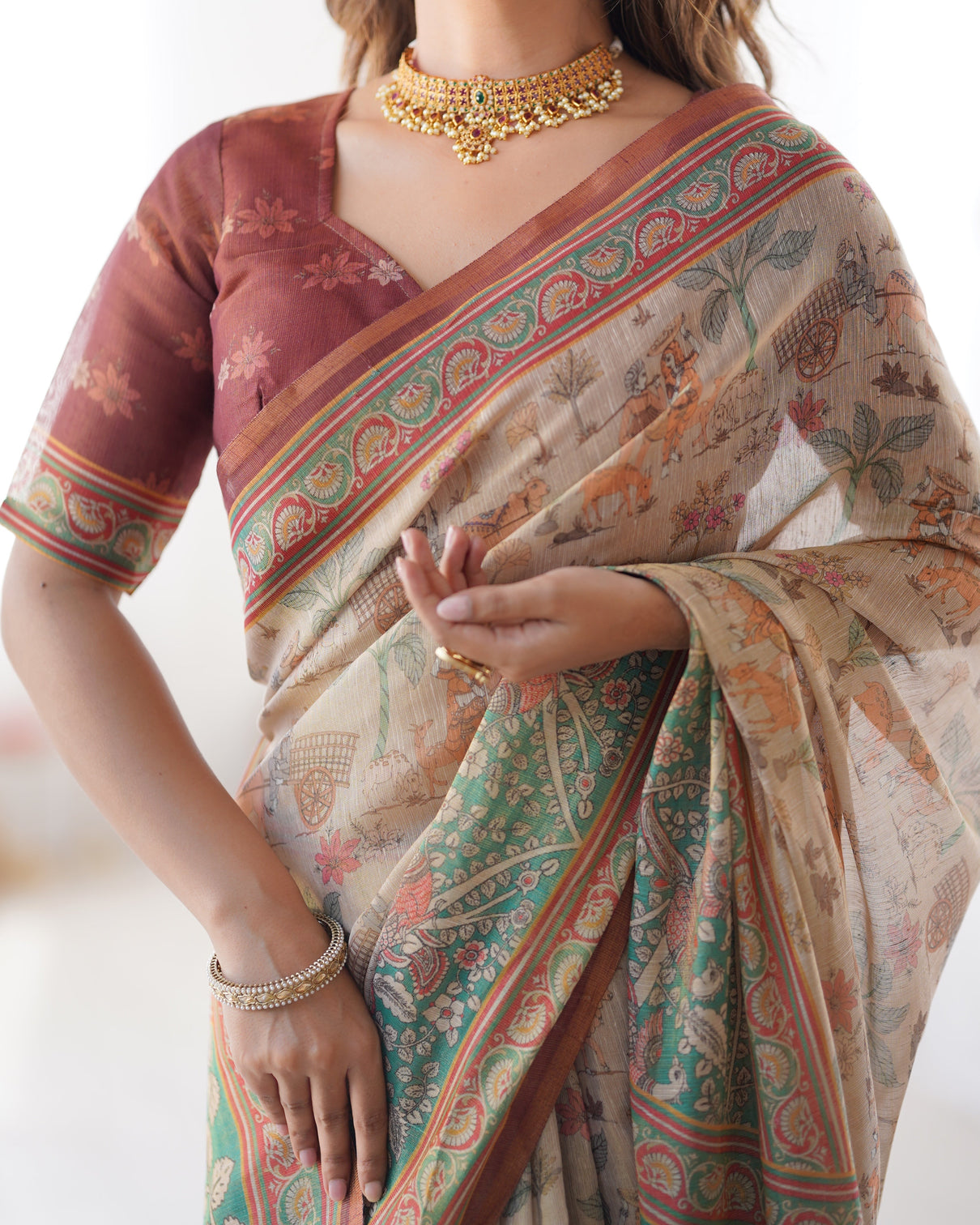 Beige green handloom cotton saree with village life print and majestic peacock pallu