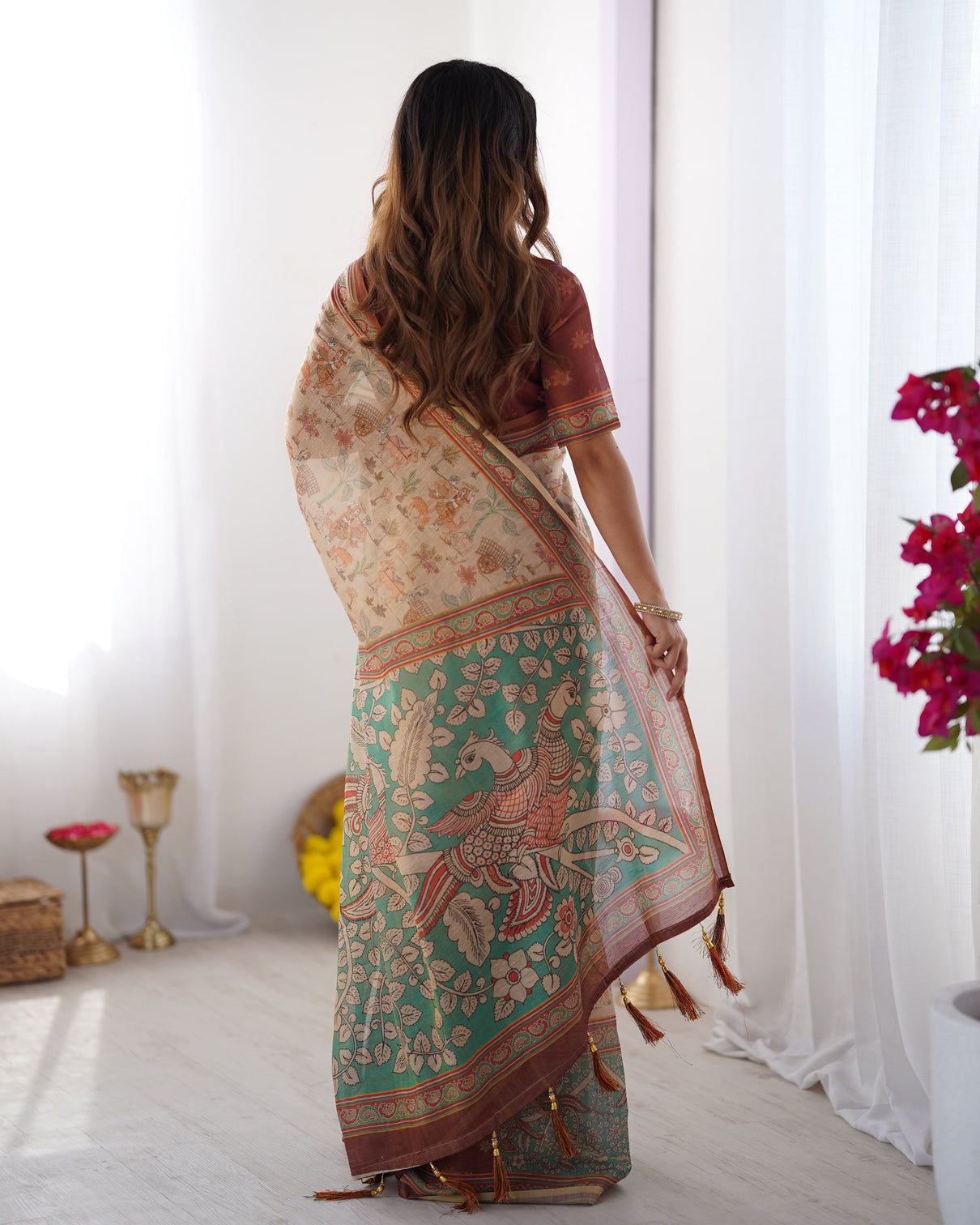 Beige green handloom cotton saree with village life print and majestic peacock pallu