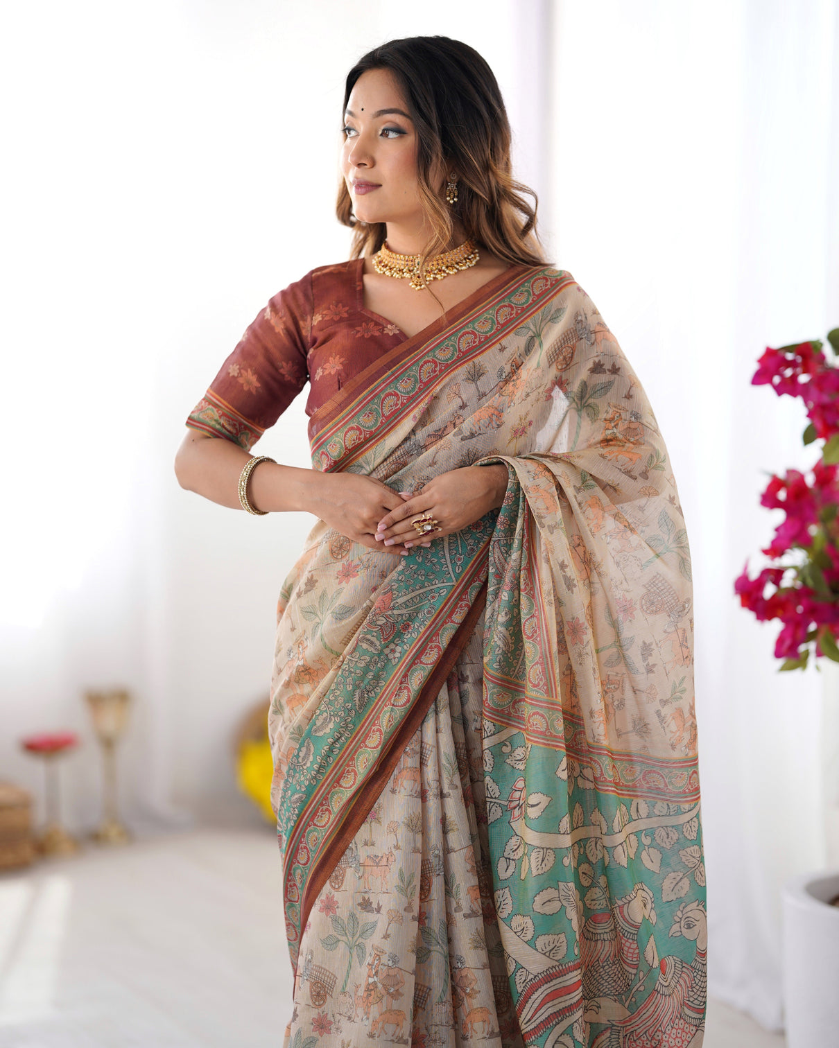 Beige green handloom cotton saree with village life print and majestic peacock pallu