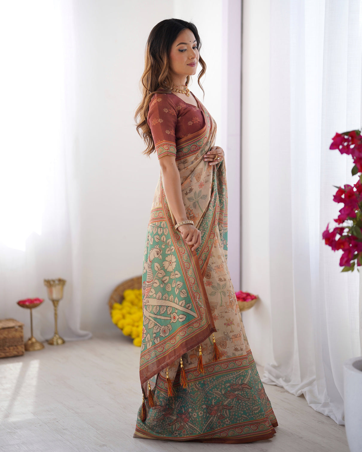 Beige green handloom cotton saree with village life print and majestic peacock pallu