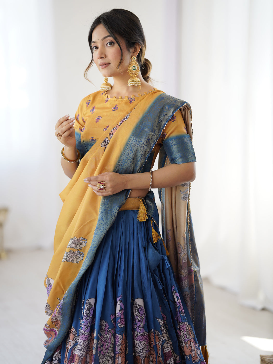 Elegant kalamkari lehenga in mustard and royal blue with flared skirt and dupatta