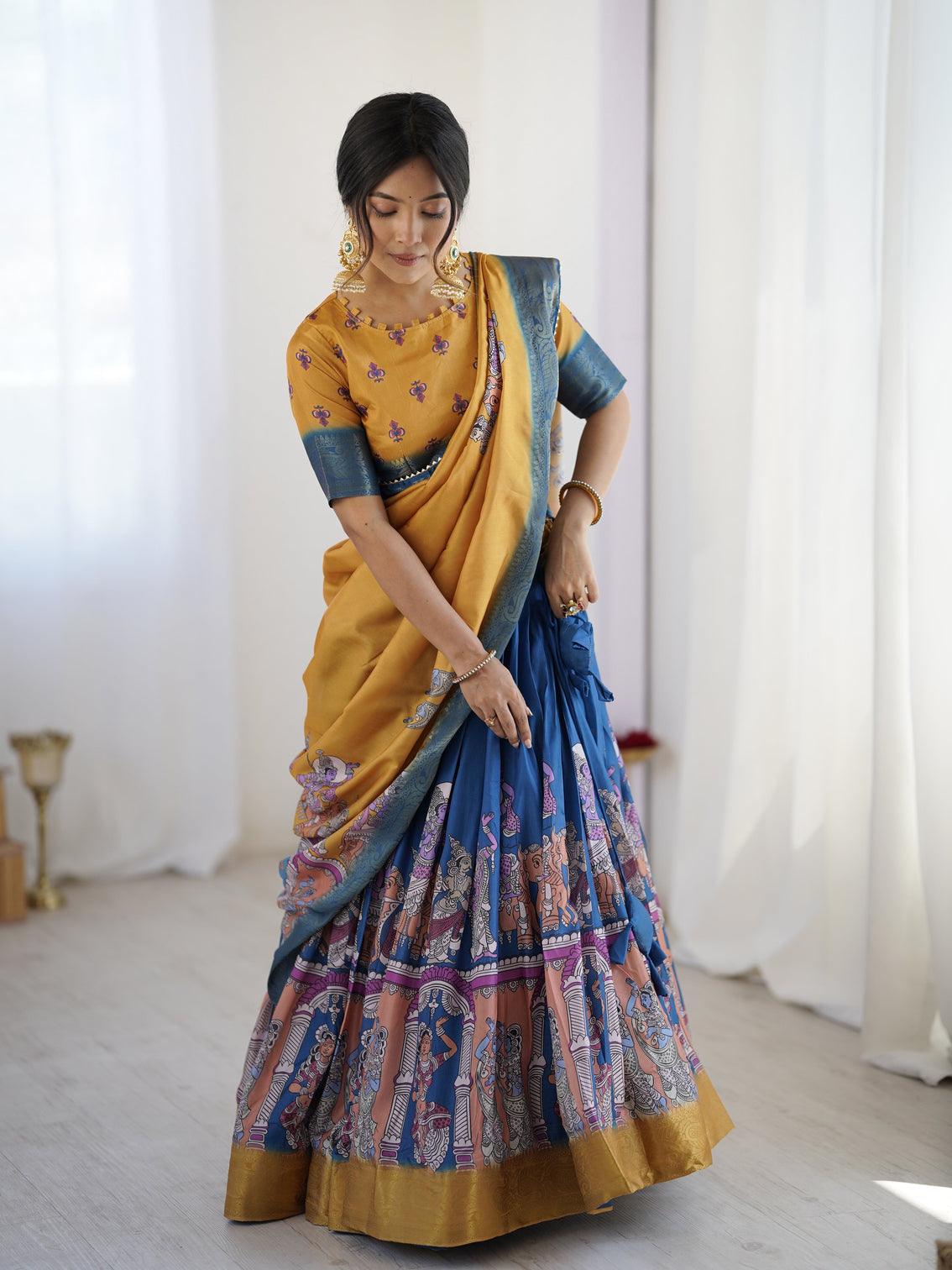 Elegant kalamkari lehenga in mustard and royal blue with flared skirt and dupatta