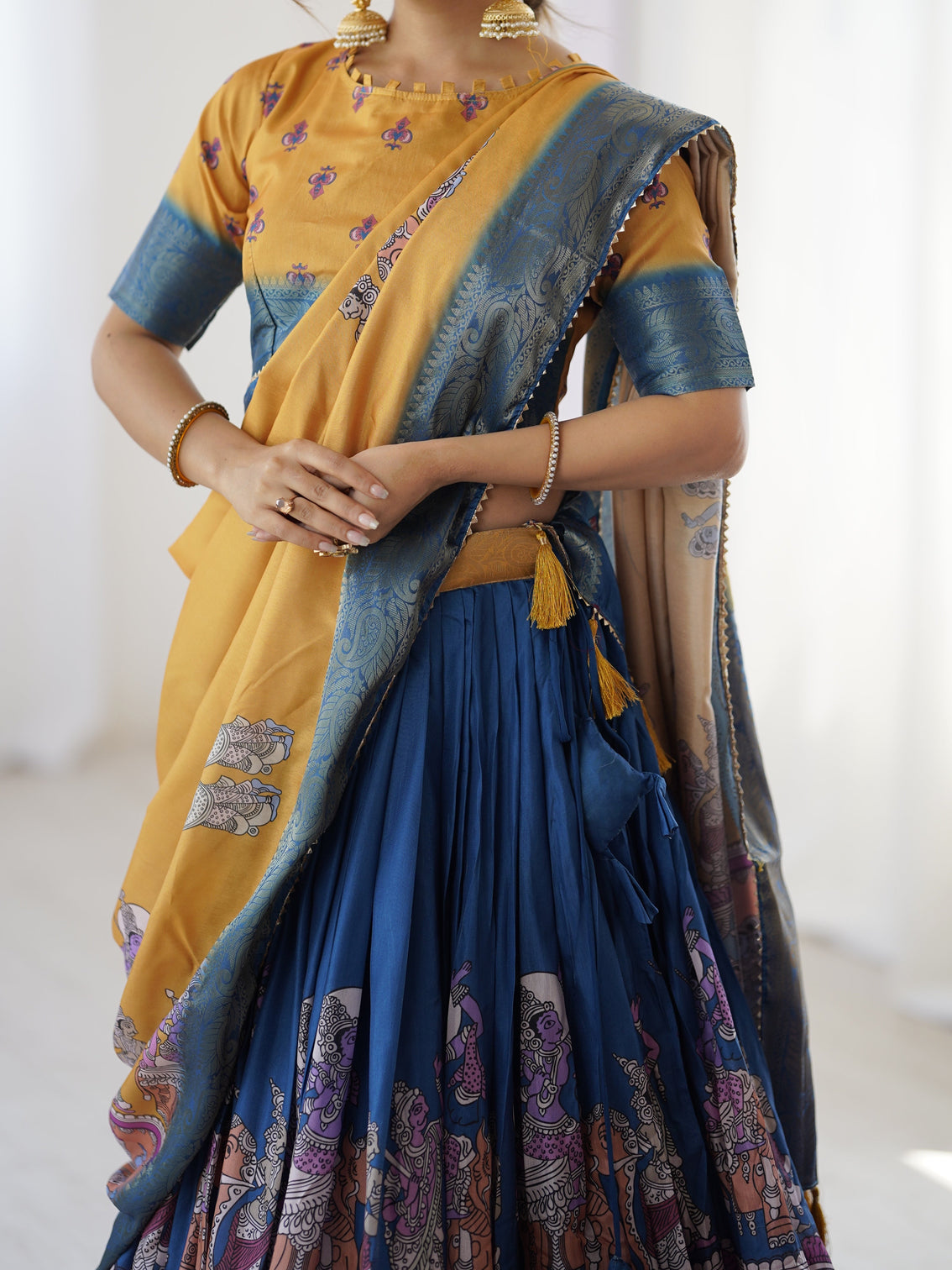 Elegant kalamkari lehenga in mustard and royal blue with flared skirt and dupatta