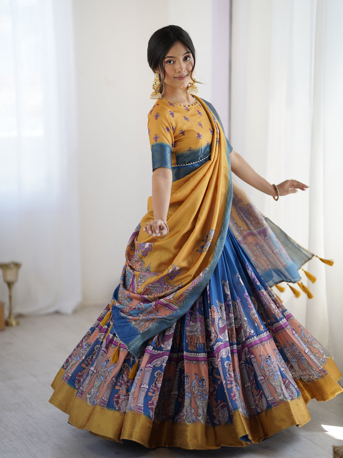 Elegant kalamkari lehenga in mustard and royal blue with flared skirt and dupatta